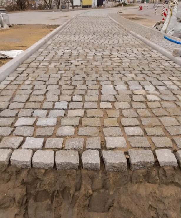 Paved cobblestone surface under construction, showcasing durable materials for roadway or parking lot projects by Strada Paving in the Greater Toronto Area.